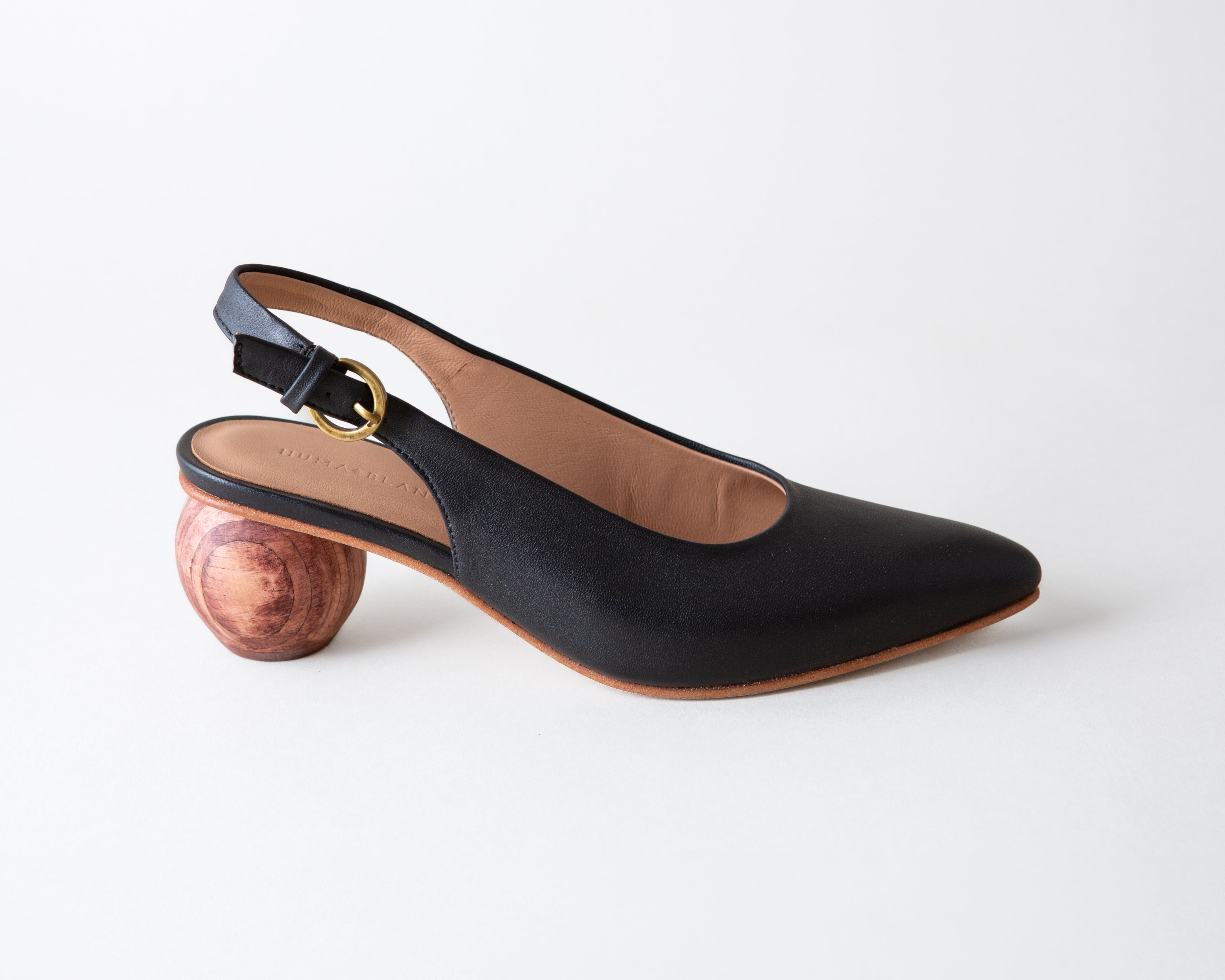 Black slingback shoe with wooden heel on a white background