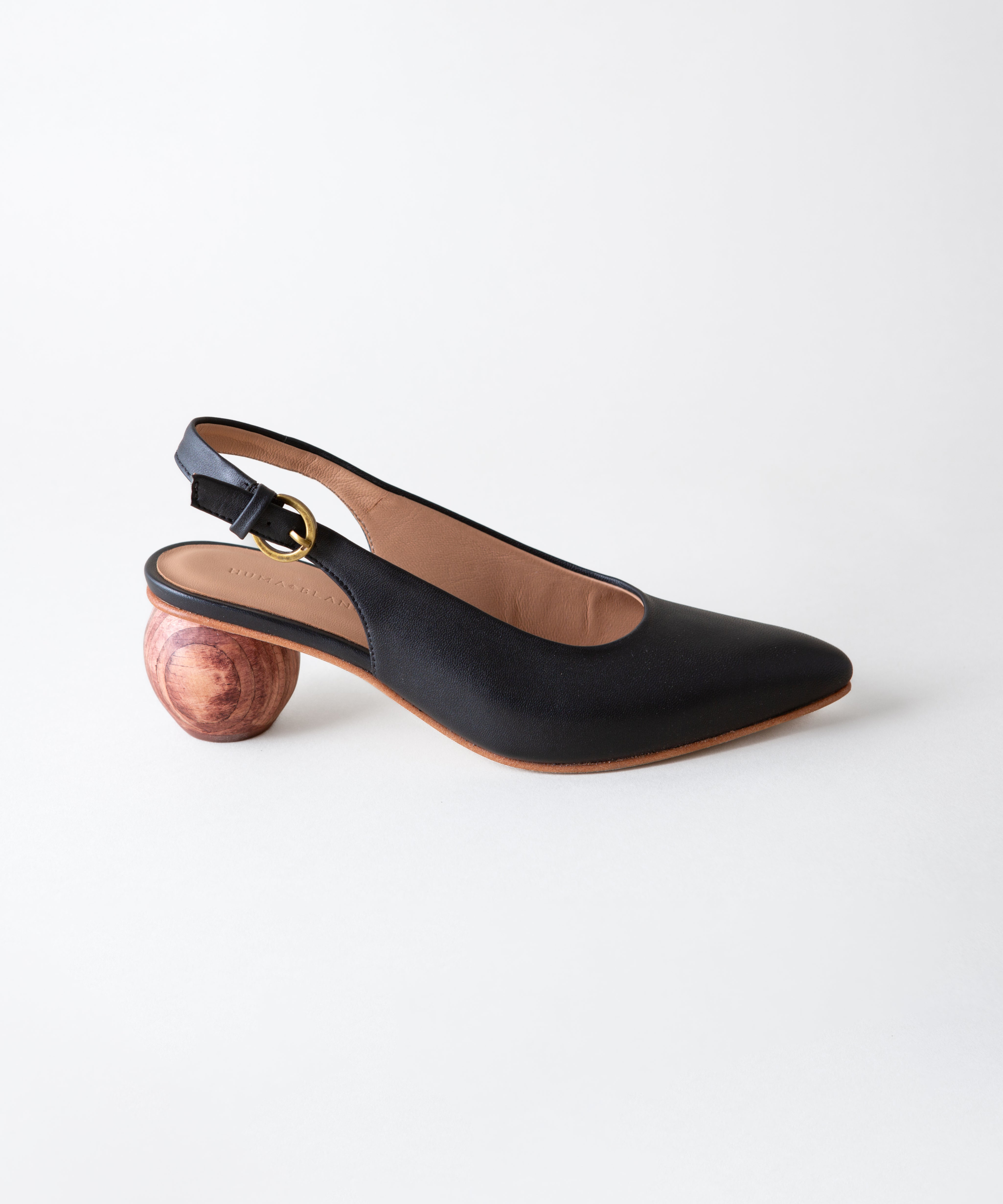 Black slingback shoe with wooden heel on a white background