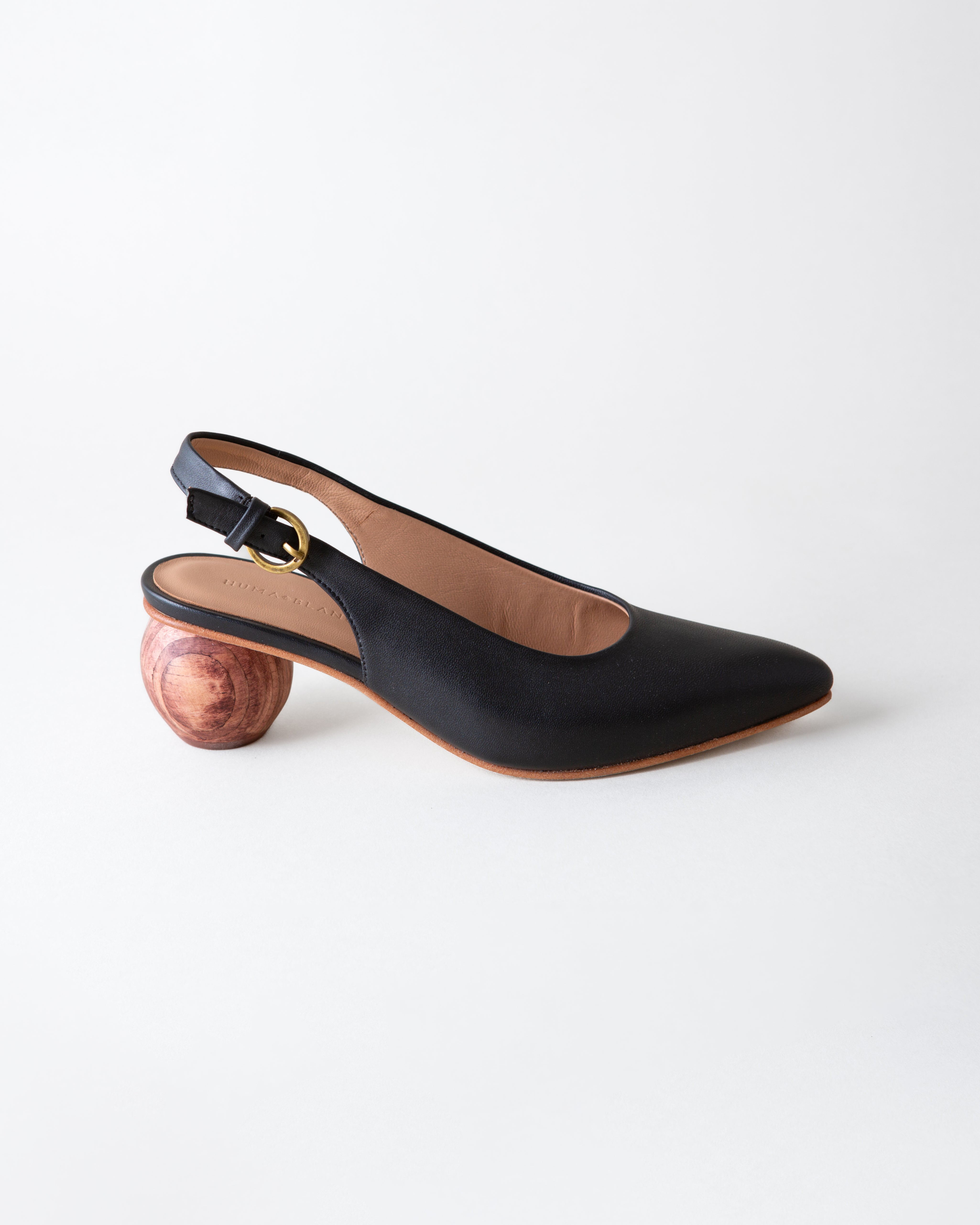 Black slingback shoe with wooden heel on a white background