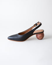Black slingback shoe with wooden heel on a white background
