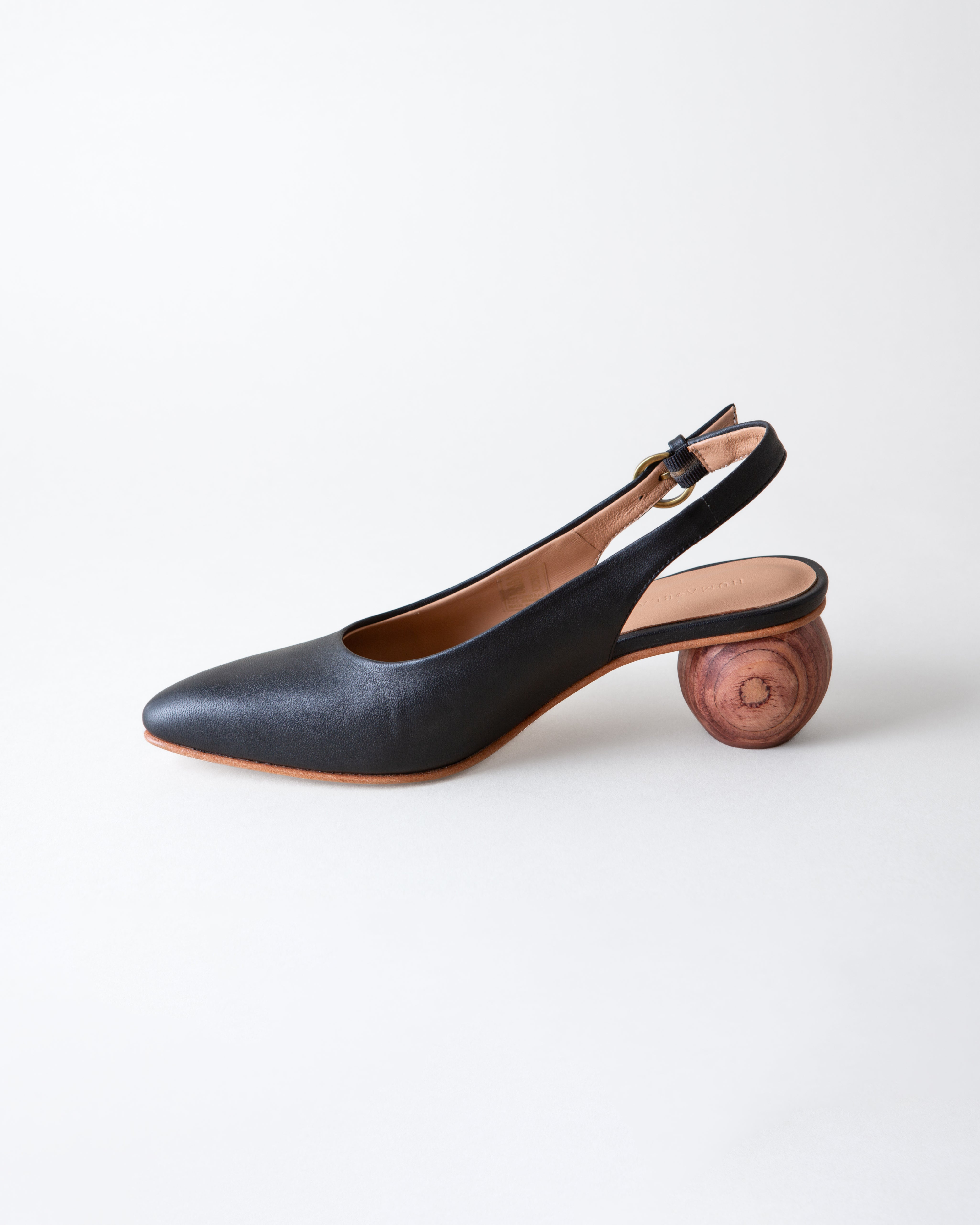 Black slingback shoe with wooden heel on a white background