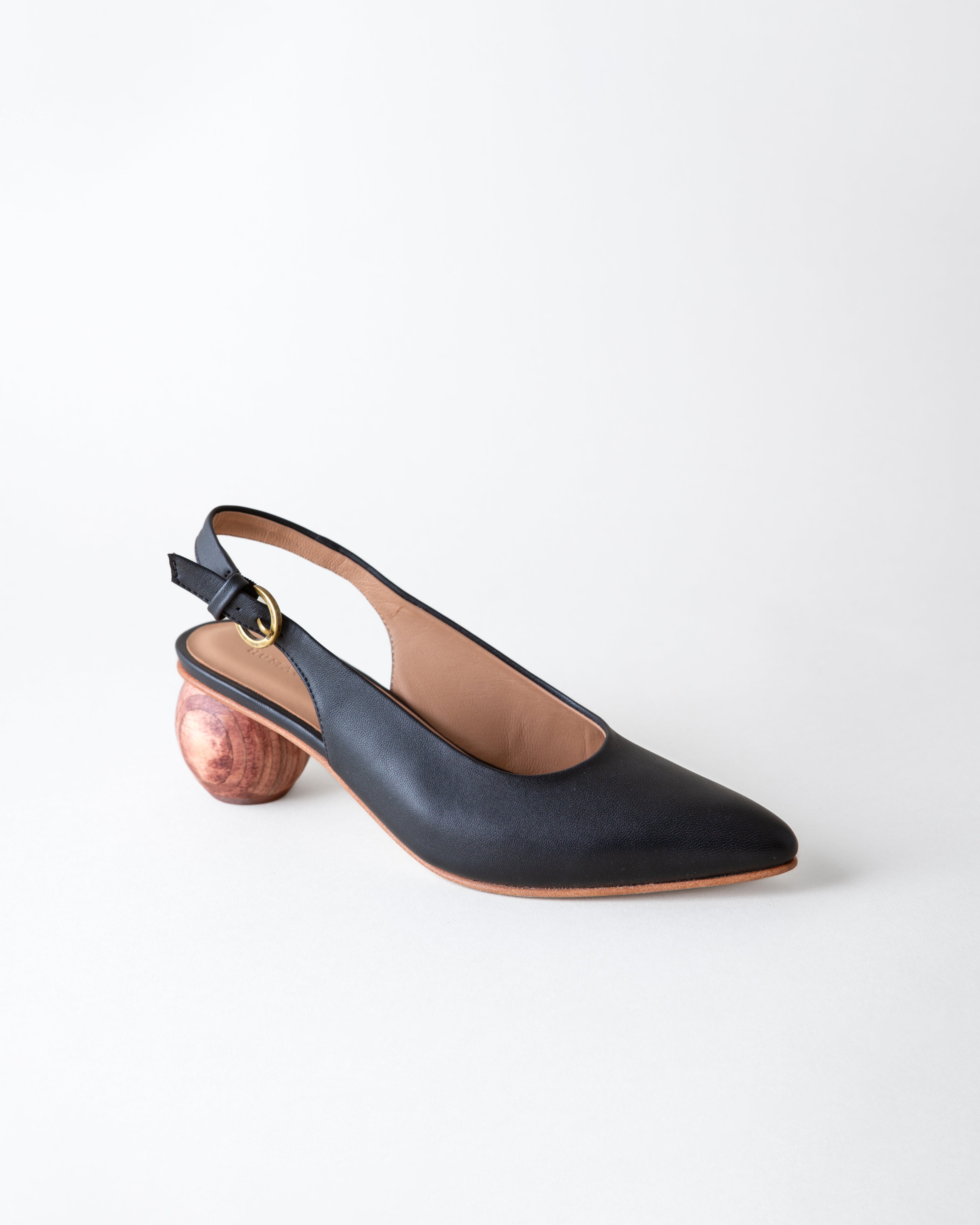 Black slingback shoe with wooden heel on a white background