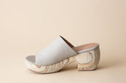 Off-white clog sandals on a beige background