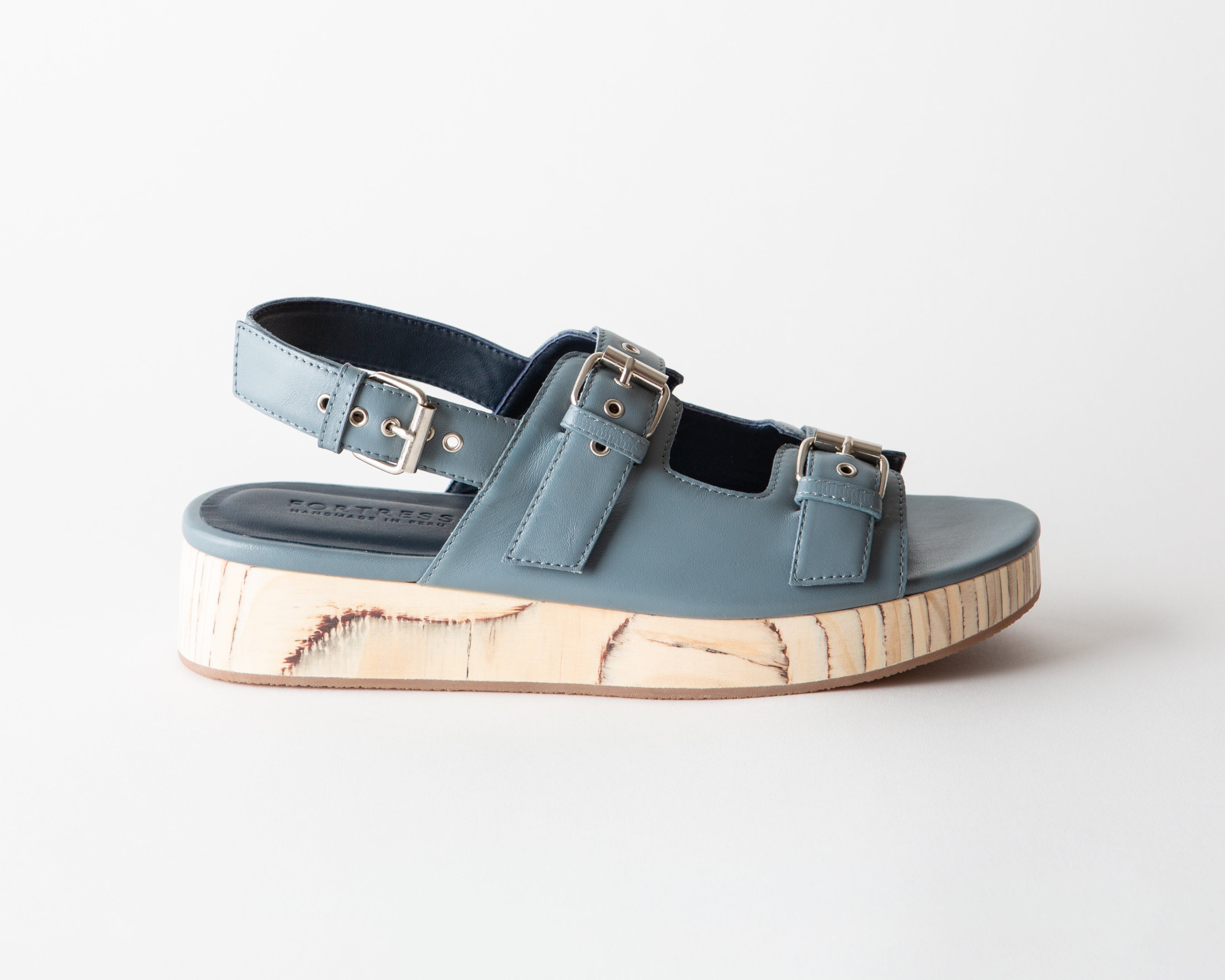 Blue sandals with cork sole on a white background