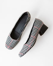 Black and white plaid heels on a white background