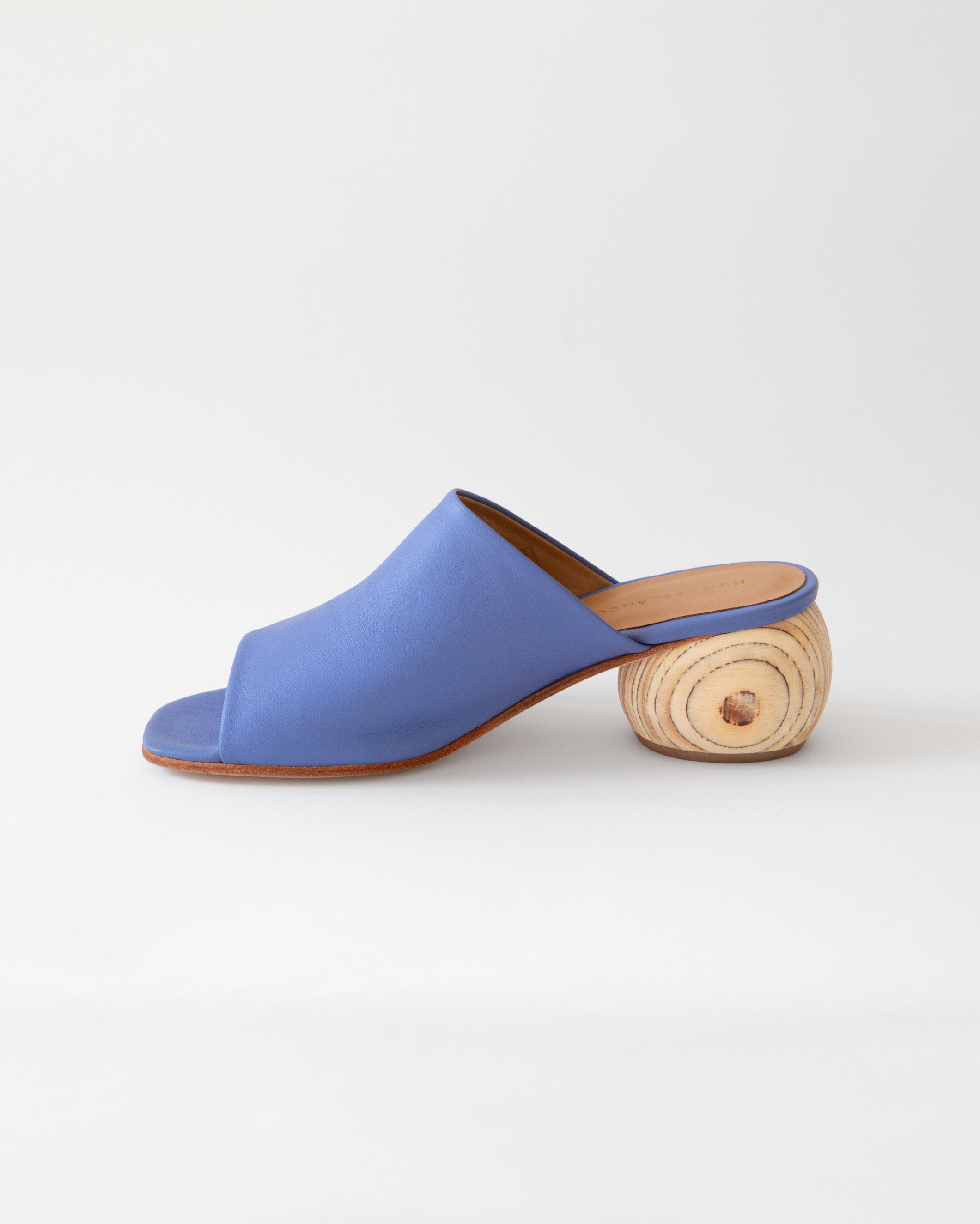 Blue sandal with wooden heel on a white background