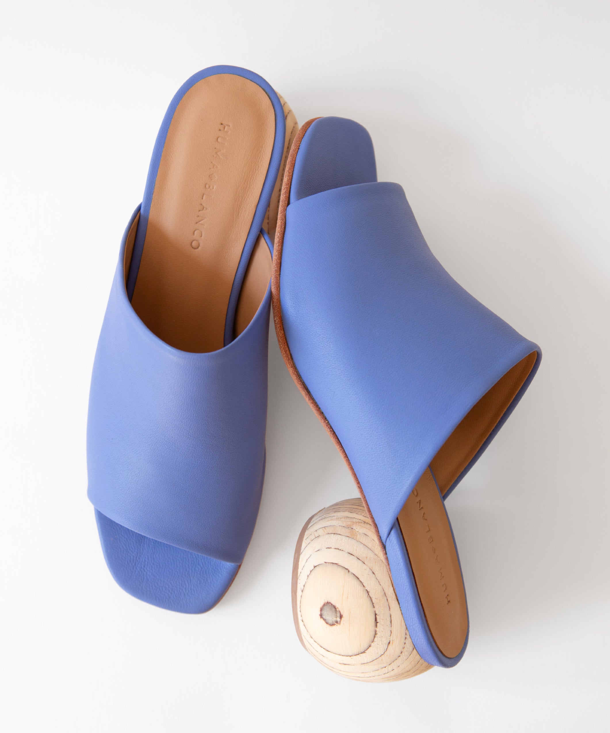 Blue sandals with wooden heels on a white background