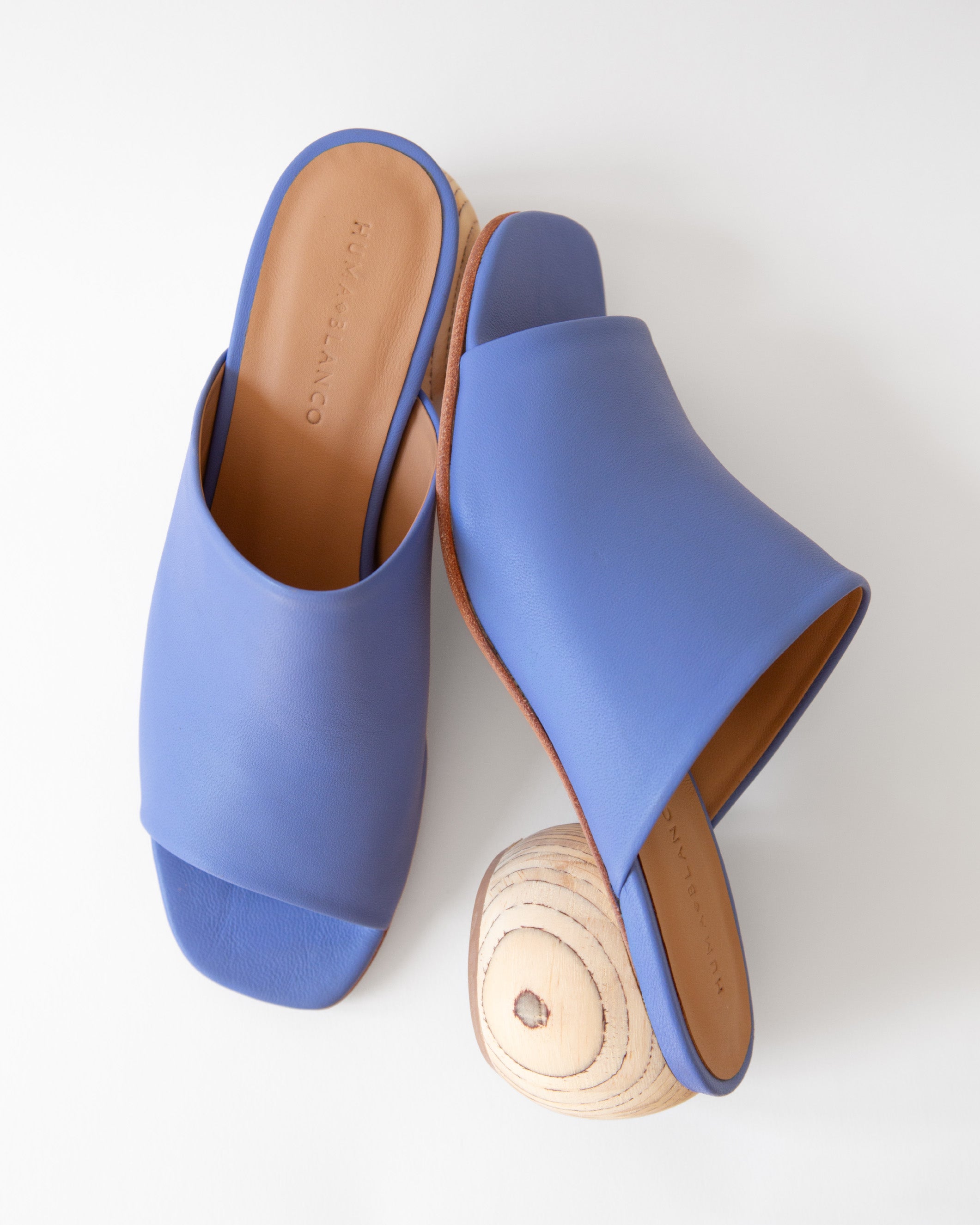 Blue sandals with wooden heels on a white background