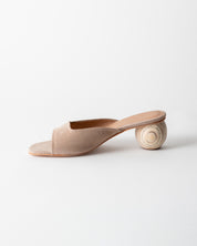 Beige sandal with wooden heel on a white background