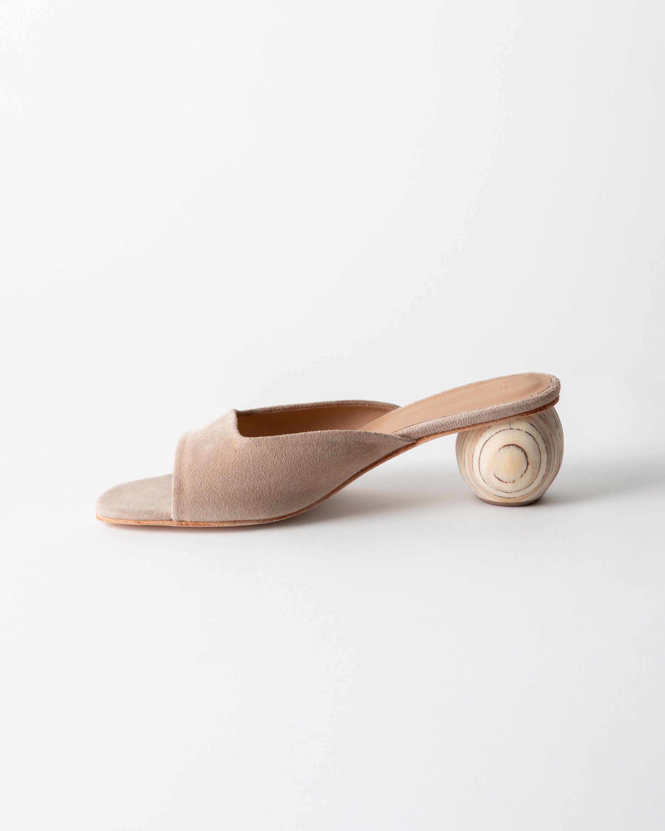 Beige sandal with wooden heel on a white background