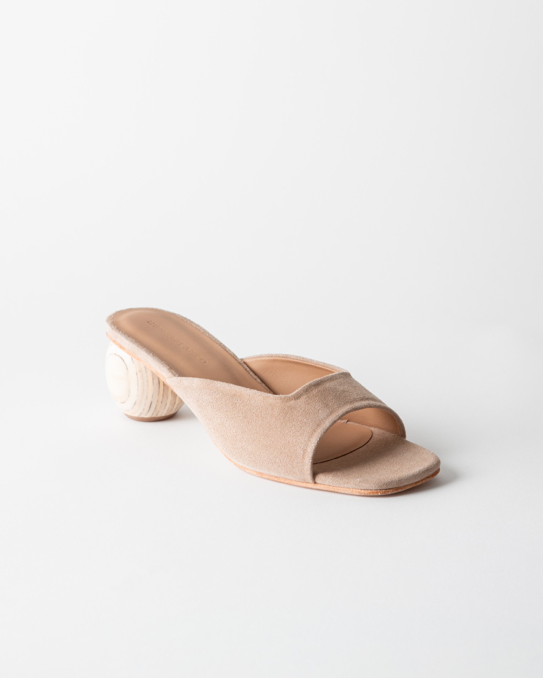 Beige sandal with wood heel on a white background