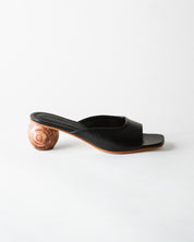 Black open-toe sandal with wooden heel on a white background