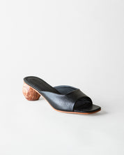 Black sandal with wooden heel on a white background