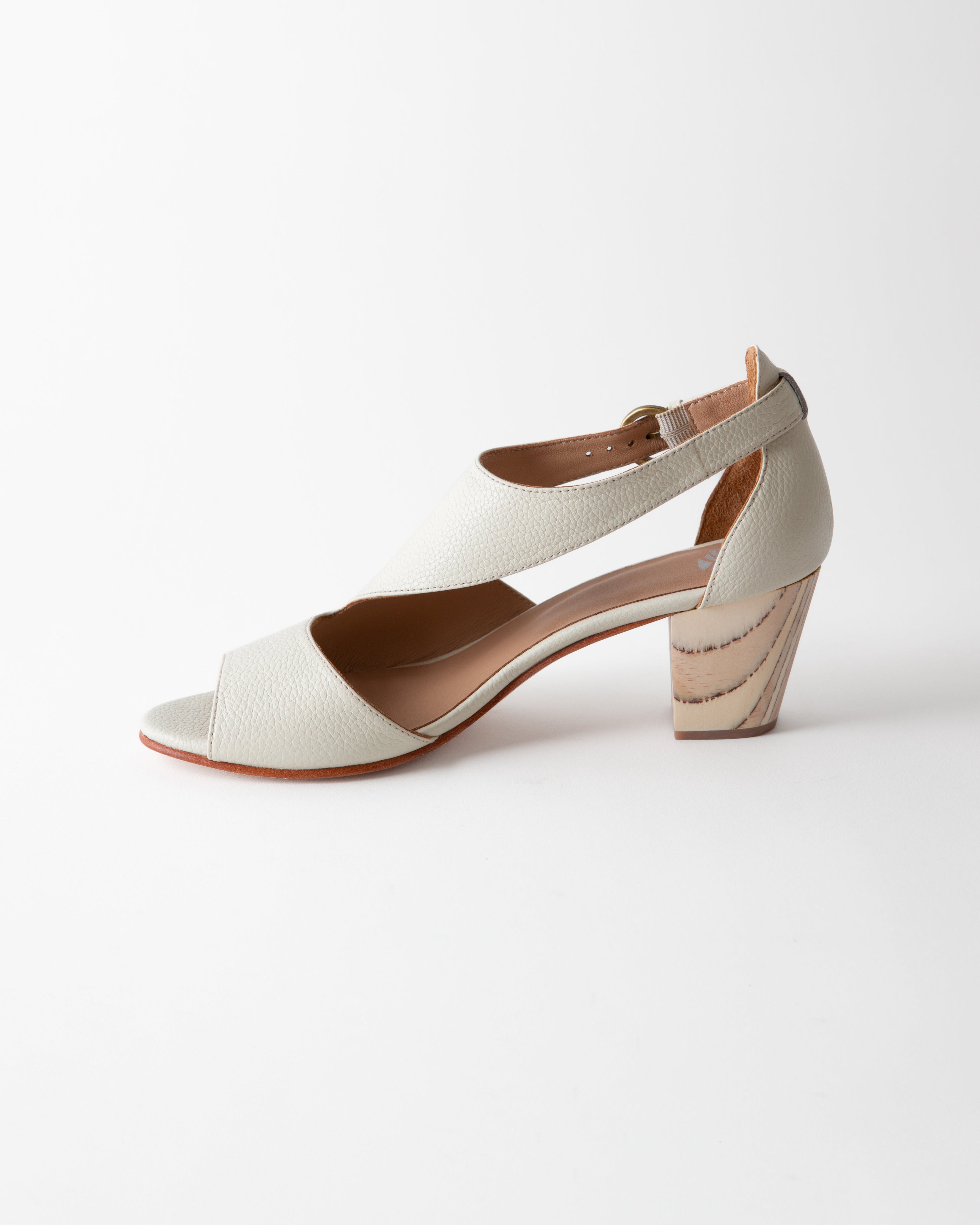 White sandal with a wooden heel on a white background