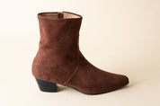 Brown suede ankle boot on a beige background